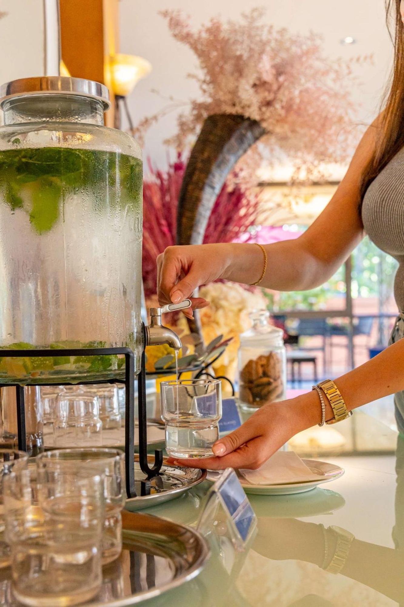 Radisson Blu Martinez Beirut Hotel ภายนอก รูปภาพ A woman filling a glass with a beverage